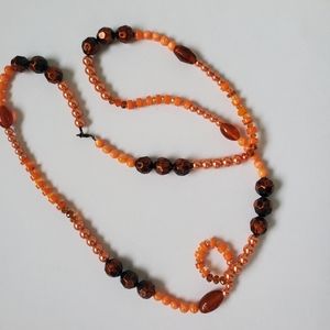 Long beaded necklace with Orange & brown beads along crystal and plastic 40"